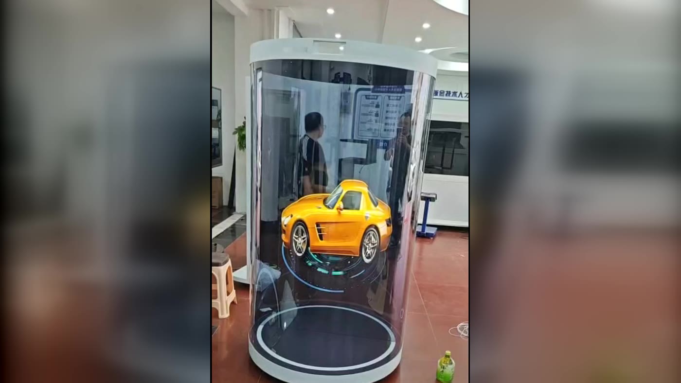 A 3D car model rendered inside the hologram stage, rotating above the lit base ring